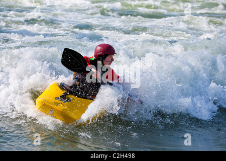 Playboating whitewater kayaker surfing on wave, Rhone River in near Lyon, Sault Brenaz, France Stock Photo