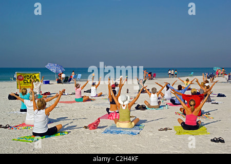 Yoga classes are held on the white sand beach of Siesta Key, a resort barrier island on the Gulf of Mexico at Sarasota, Florida. Stock Photo