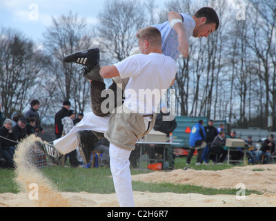 Swiss wrestling athletes fight for victory by throwing their opponent on his back April , Bonstetten, Switzerland Stock Photo