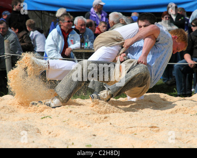 Swiss wrestling athletes fight for victory by throwing their opponent on his back April , Bonstetten, Switzerland Stock Photo