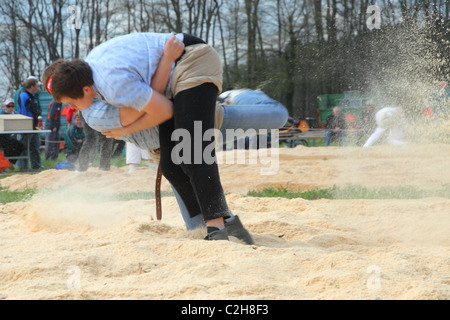 Swiss wrestling athletes fight for victory by throwing their opponent on his back April , Bonstetten, Switzerland Stock Photo