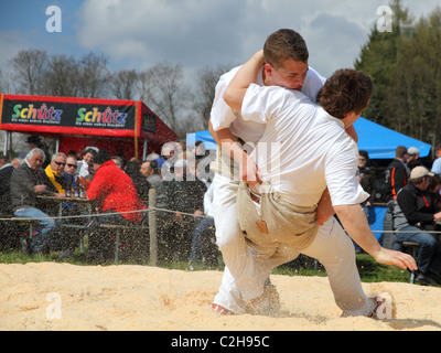 Swiss wrestling athletes fight for victory by throwing their opponent on his back April , Bonstetten, Switzerland Stock Photo