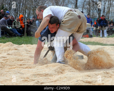 Swiss wrestling athletes fight for victory by throwing their opponent on his back April , Bonstetten, Switzerland Stock Photo