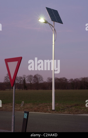 Energy efficient  stand alone Led road lighting turned on with solar panel as power source Stock Photo
