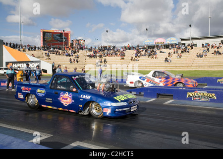 Two heavily modified and supercharged Australian Holden ute drag racing cars line up to race on the quarter mile drag strip Stock Photo