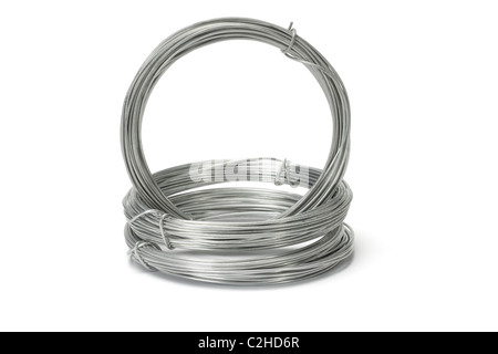 Coils of galvanized wires stacked on white background Stock Photo
