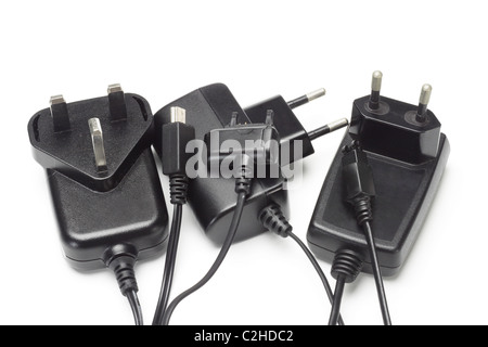 Assorted mobile phone chargers and adapters on white background Stock Photo