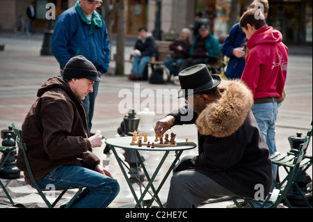 Chess players play chess outside on the street in a sunny afternoon in Seattle Stock Photo