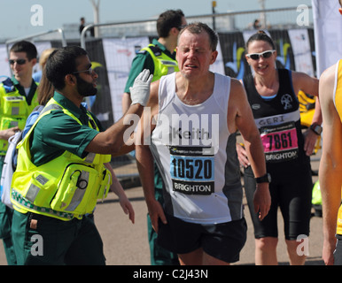 A runner being helped by a medic after completing the Brighton Marathon 2011 UK Stock Photo