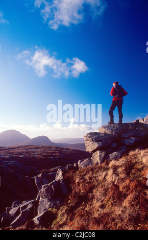 Walker looking towards Errigal Mountain from Dooish. Glenveagh National Park, Derryveagh Mountains, Co Donegal, Ireland. Stock Photo