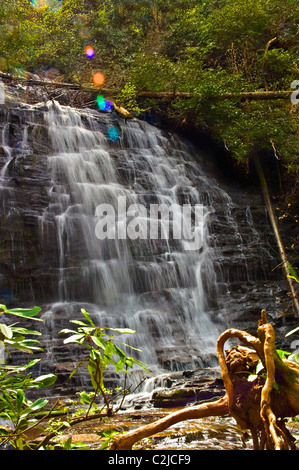 A beautiful waterfall with sun coming in over it making colorful spots flowing down. Stock Photo