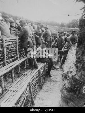 German Soldiers relax in their deep trenches which in the Stalemates of WWI have become a home. Stock Photo