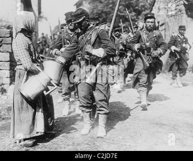 Peasant Woman provides water to passing French Troops Stock Photo