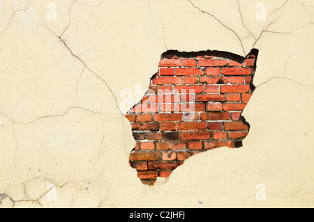 Old weathered brick and stucco wall fragment Stock Photo