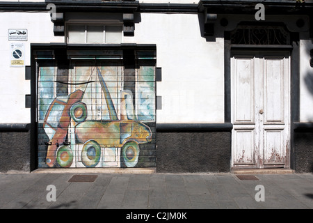 No parking advise in La laguna, picture of tow truck painted on garage door Stock Photo