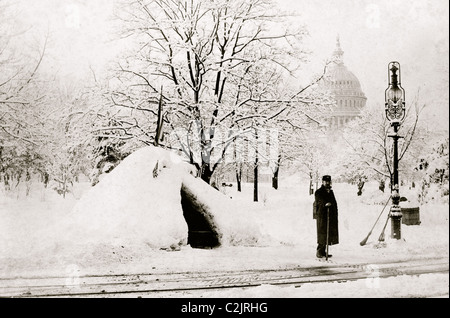 Man standing by snow hut, after blizzard of 1888, with U.S. Capitol in background, Washington, D.C. Stock Photo