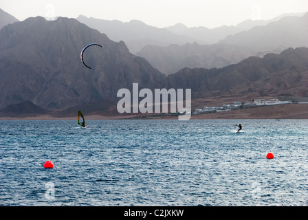 Surfers in blue lagoon - Dahab, Sinai peninsula, Egypt Stock Photo