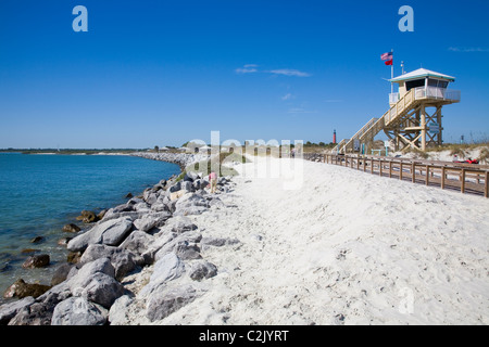 A convenient boardwalk leads from the a pristine beach to the fishing pier at Ponce Inlet, Daytona Beach, FL Stock Photo