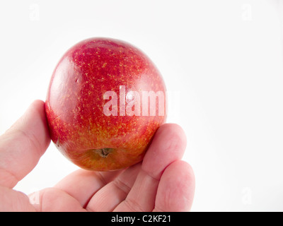 A beautiful red apple in a man's hand Stock Photo