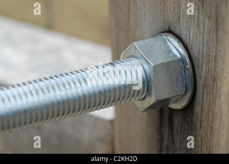 Hex bolt, nut and washer on an outdoor wooden gate. Stock Photo