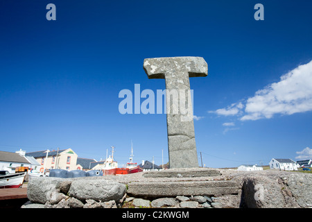 12th-century Tau Cross beside the harbour in West Town, Tory Island, County Donegal, Ireland. Stock Photo