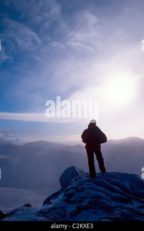 Winter walker at the summit of Slieve Bearnagh, Mourne Mountains, County Down, Northern Ireland. Stock Photo