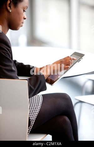 young woman using apple ipad in modern office Stock Photo