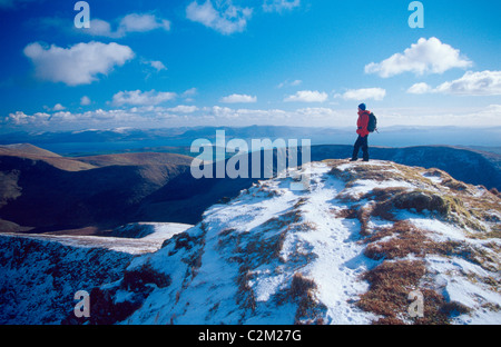 Winter walker on the summit of Gearhane, Brandon massif, Dingle Peninsula, County Kerry, Ireland.