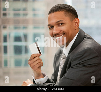 African american businessman holding credit card standing over isolated ...