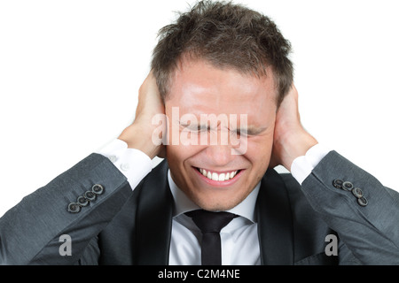 Young man, holding hands on his ears, protecting himself from noise Stock Photo