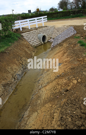 Culvert, channel water, underneath road, railway, embankment, drainage, running water, flooding, projects, land, works, tunnel, flood prevention, silt Stock Photo