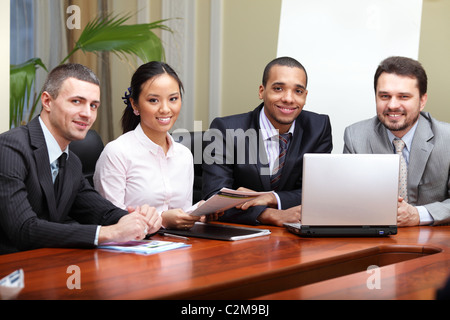 Multi ethnic business team at a meeting. Interacting. Focus on african-american man Stock Photo