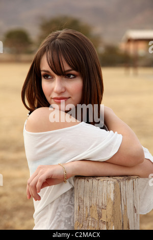 Pretty young Hispanic woman wearing a white blouse Stock Photo