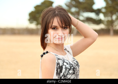 Pretty young Hispanic woman wearing a white blouse Stock Photo