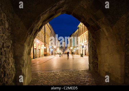 The archway of the Florian Gate, the main entrance into the city, looking down the Royal Road in Krakow, Poland, Eastern Europe Stock Photo