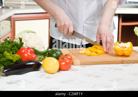 beautiful woman prepares food in the kitchen Stock Photo