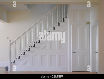 White painted panelled door and staircase Stock Photo