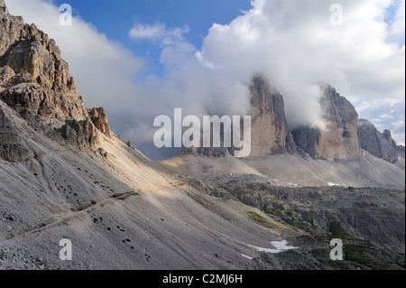 The eroded mountain peaks of the Tre Cime di Lavaredo / Drei Zinnen, Dolomites in the clouds, Italy Stock Photo