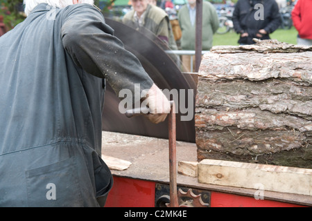 Men demonstrating the Cutting of wood with Tractor driven Rack Saw   Old Working Farm Machinery Stock Photo