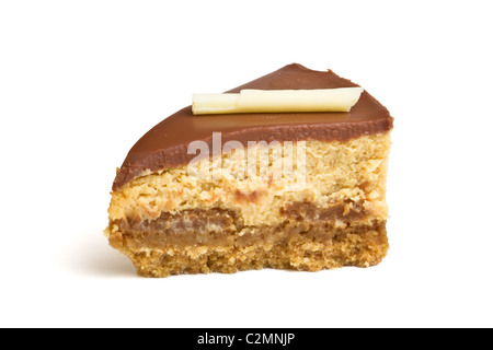 Chocolate caramel cheesecake wedge isolated on white from low perspective. Stock Photo