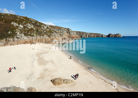 Porthcurno beach and a calm turquoise sea, with Logan rock in the distance.  Cornwall UK. Stock Photo