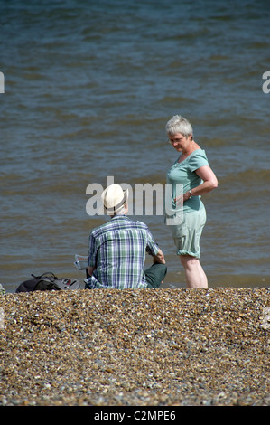 older man and woman on beach Stock Photo
