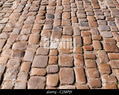 Cobble stones on an old cobbled street close up, UK Stock Photo