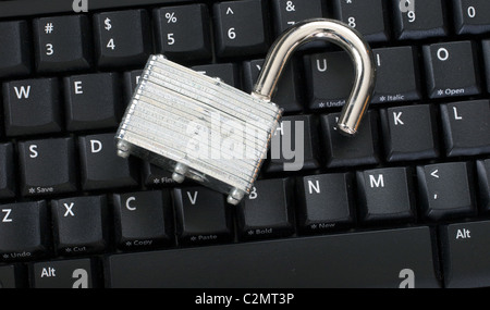 Unlocked padlock on keyboard representing an information security breach Stock Photo