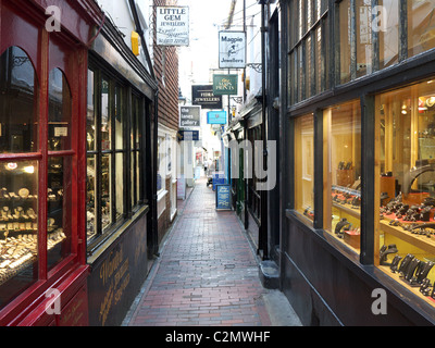 A view along a long narrow passageway between shops in The Lanes Brighton Stock Photo