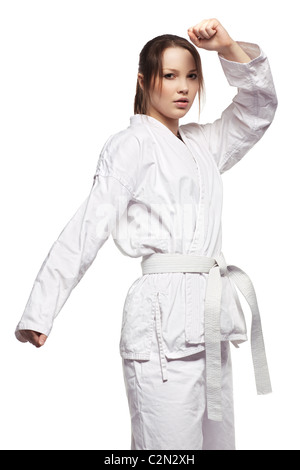 isolated portrait of beautiful martial arts girl in kimono excercising karate kata Stock Photo