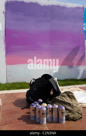 Blank Canvas & spray cans   Unfinished work at the Graffiti Fest   Legal Art wall at Southport Pleasure Beach, Merseyside, UK Stock Photo
