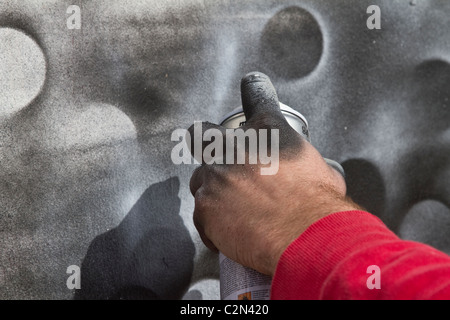 Fingers covered in paint at the spray paint Graffiti Fest   Legal Art wall at Southport Pleasure Beach, Merseyside, UK Stock Photo