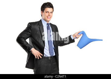 Portrait of a young businessman holding a watering can Stock Photo