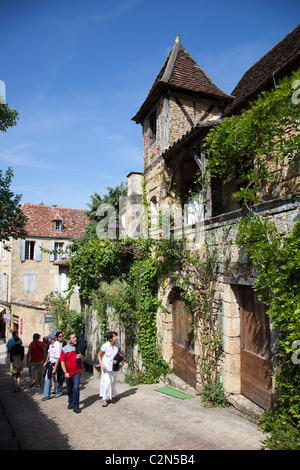 People in street with mediaeval buildings Sarlat-la-Caneda Dordogne France Stock Photo